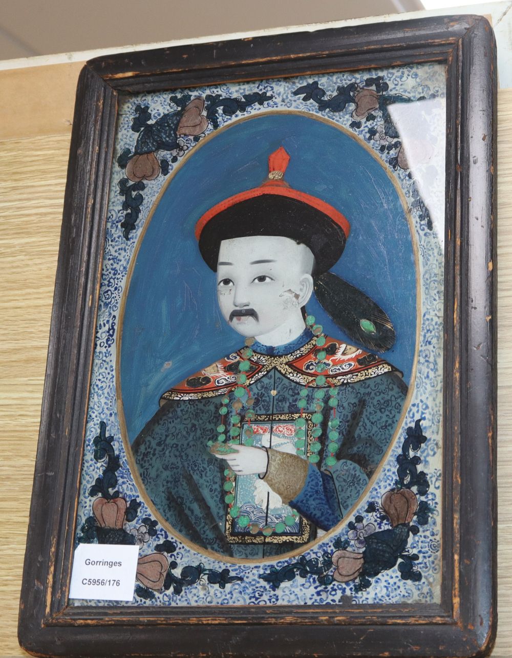 19th century Chinese School, reverse painting on glass, Portrait of a Chinese man with jade bead necklace, 33 x 22cm